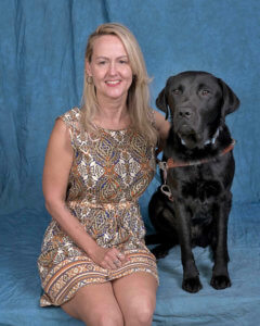 Graduate Amy and black Lab guide Elvin