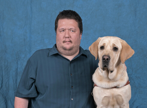 Graduate Joseph and yellow Lab guide dog Coach