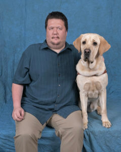 Graduate Joseph and yellow Lab guide dog Coach