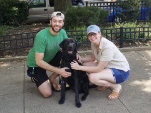 Future guide dog Edwin with raisers kneeling