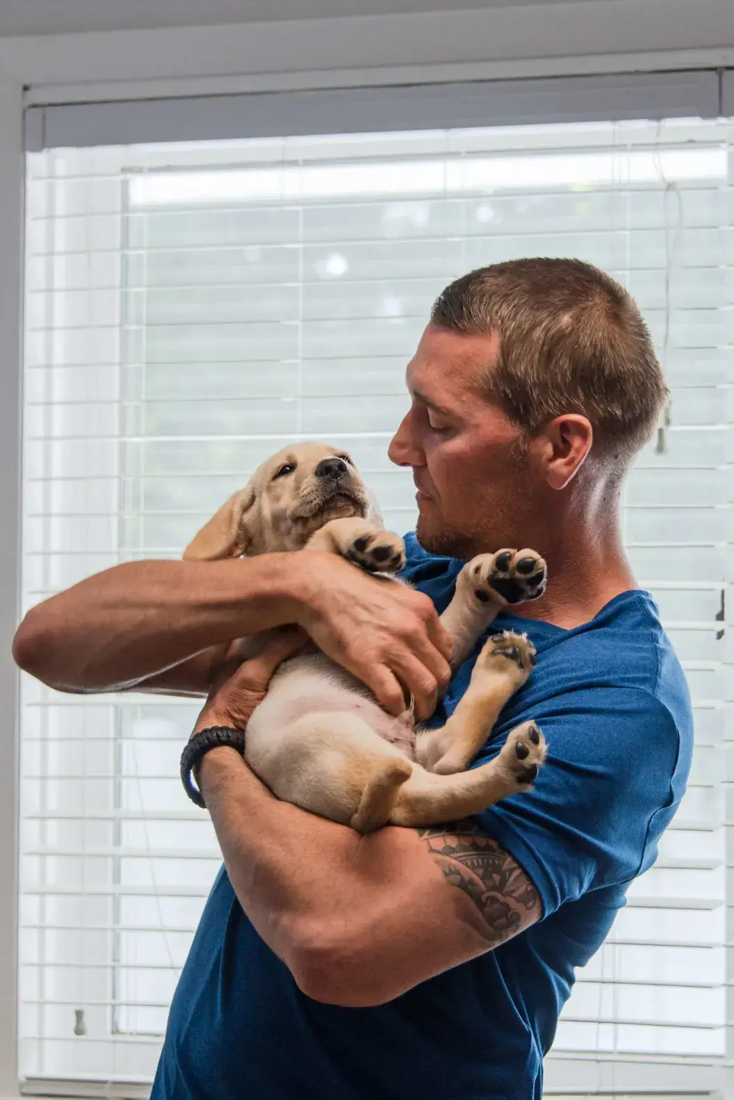 Lucky Dog host Brandon shares a quiet moment with a yellow lab puppy