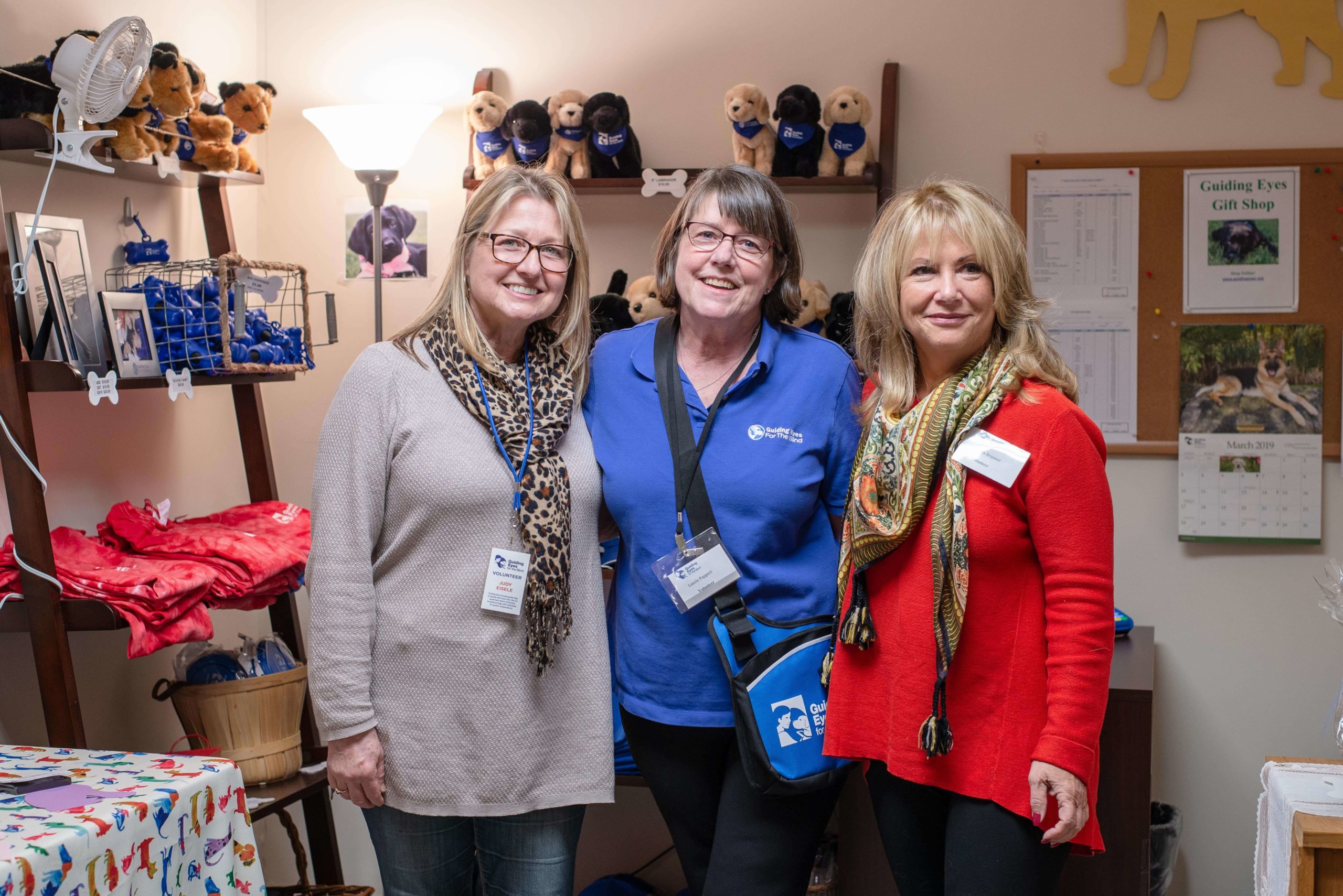 Gift shop volunteers pose for a photo during a calm moment after a graduation ceremony.