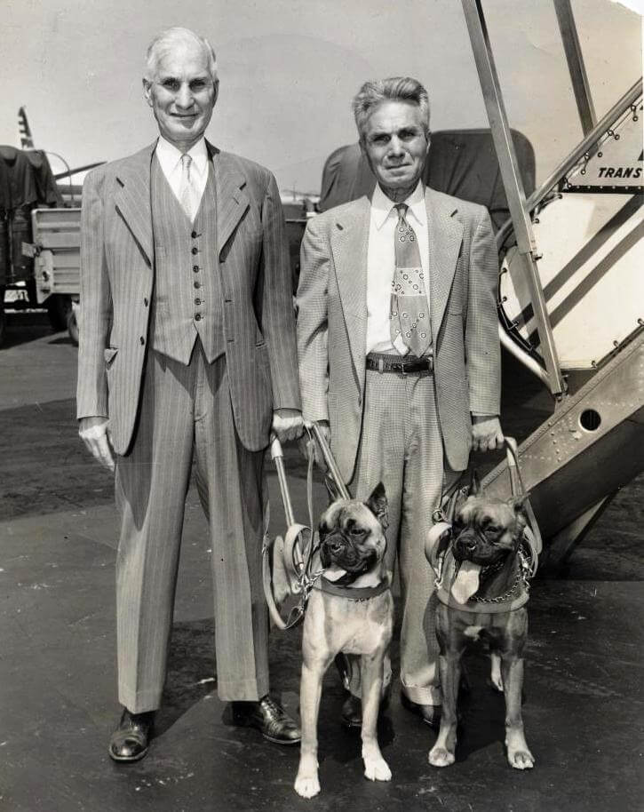 Guiding Eyes dogs have enabled independent travel for many years. Here our first two graduates - George and Ellsworth McKnight - board their plane to head home.