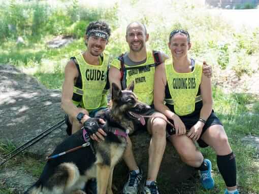 Image of ultra-marathoner Scott Jurek with Guiding Eyes CEO Thomas Panek and guide dog instructor Jolene along with guide dog Klinger.