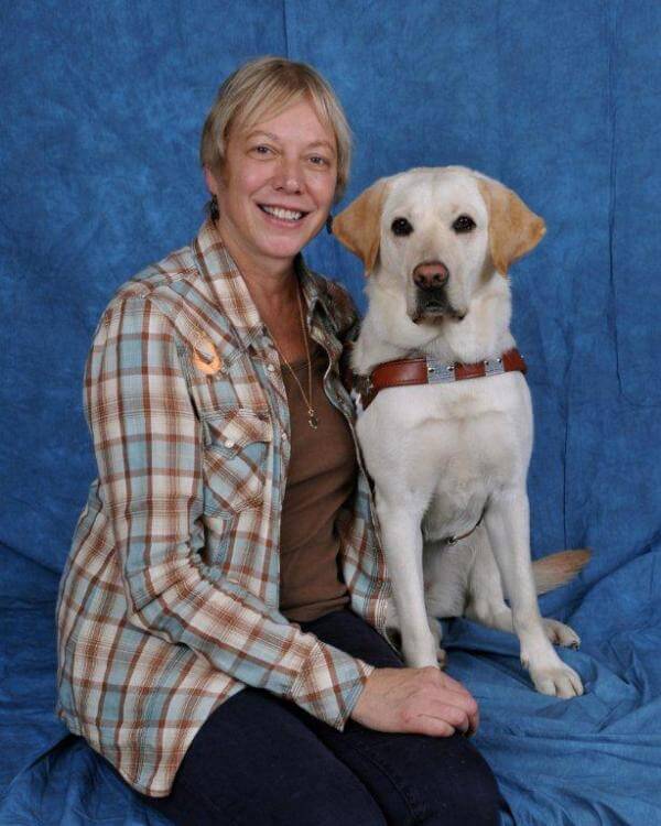 Graduate Deni Elliott with yellow Labrador guide dog Alberta