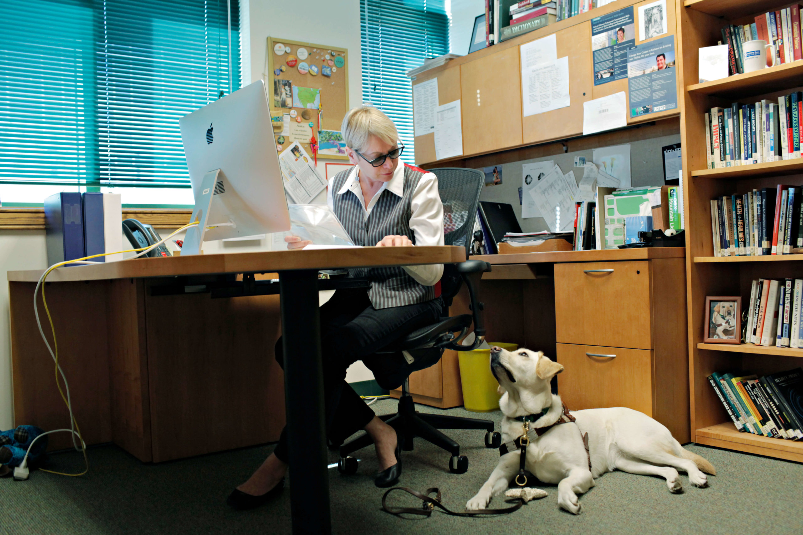 Deni Elliott at her desk with Guiding Eyes Alberta.  Photo by Melissa Lyttle (5)