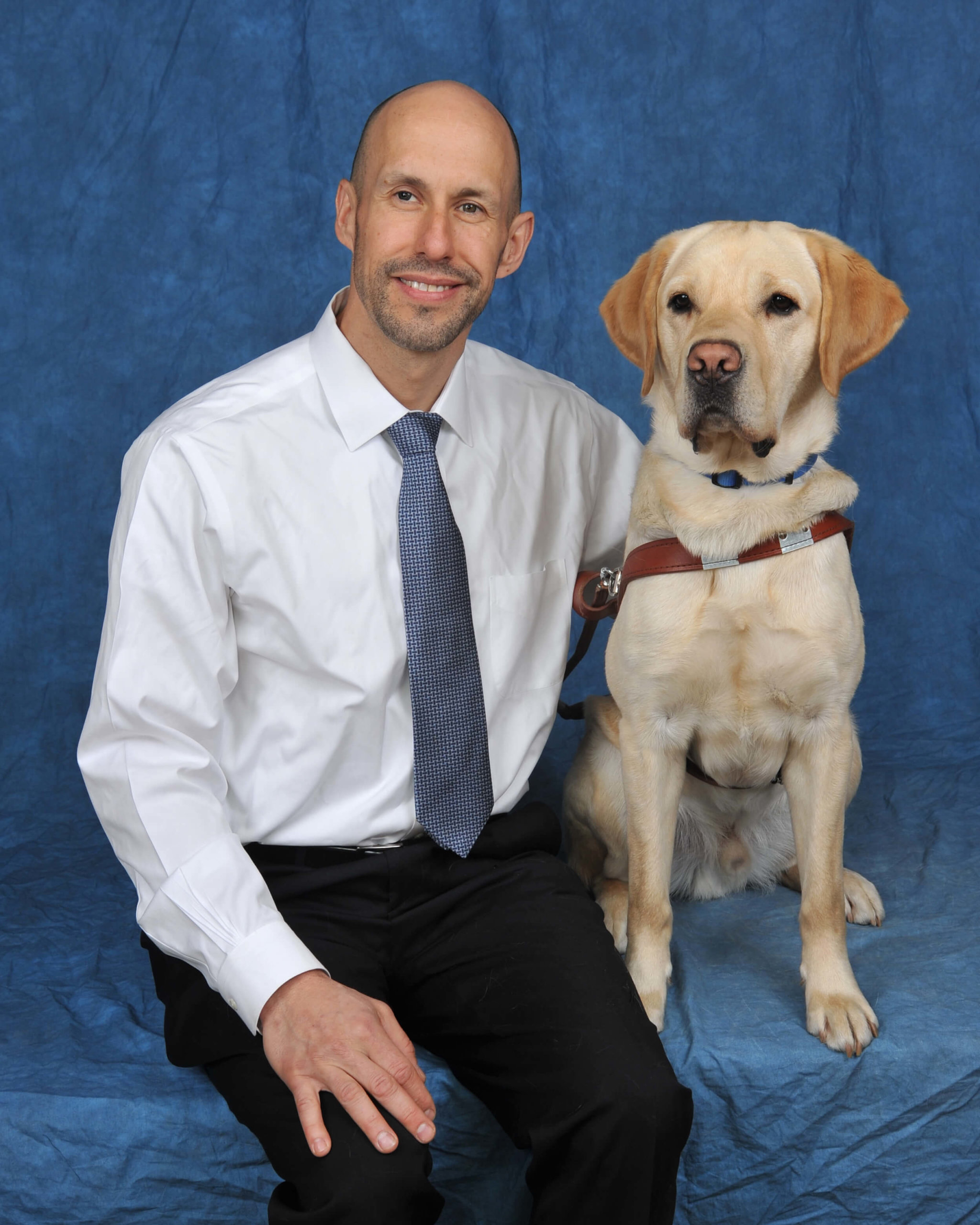 Guiding Eyes CEO Tom Panek with yellow Lab guide dog, Gus