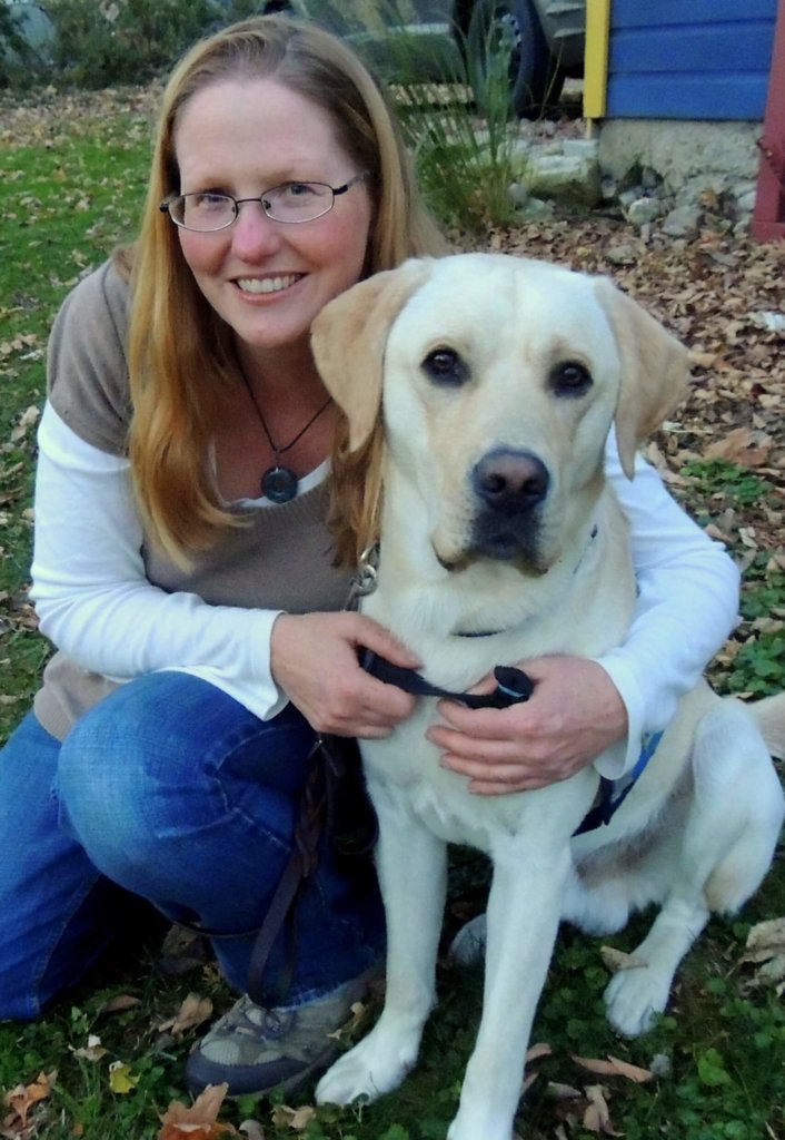 Guiding Eyes volunteer puppy raiser Tara Schatz with yellow Labrador Nacho