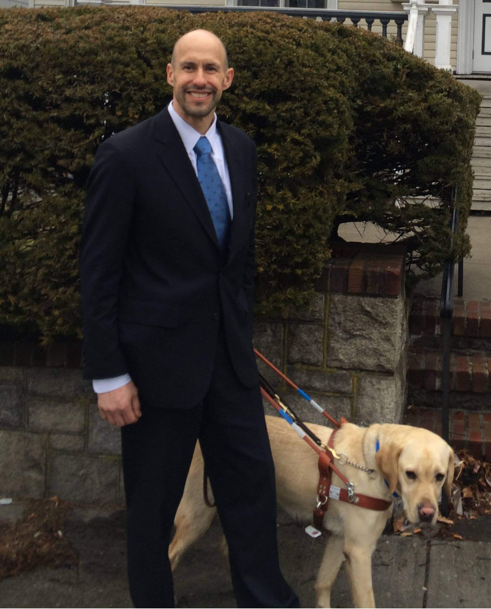 Guiding Eyes CEO Tom Panek with yellow Lab guide dog Gus