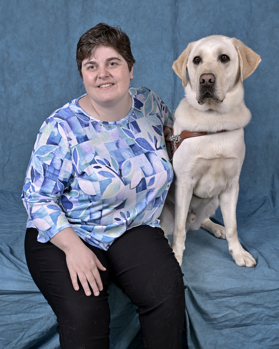 Graduate Alexis and yellow Lab guide dog Armstrong