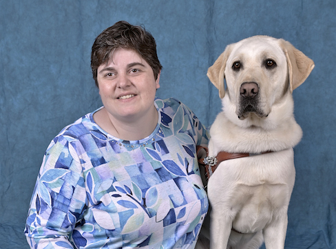 Graduate Alexis and yellow Lab guide dog Armstrong