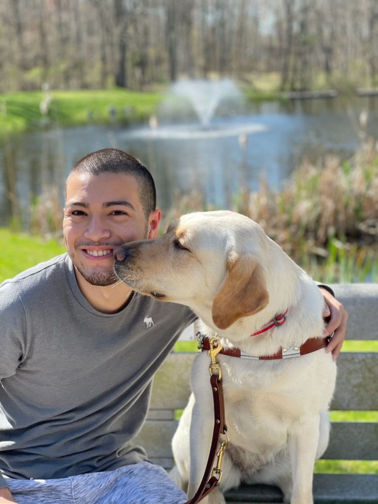 Vangie gives a kiss to handler Arturo