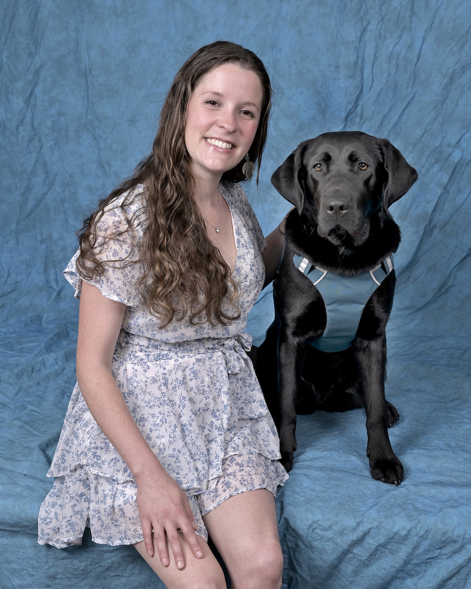 Graduate Ashley and black Lab guide Lolly