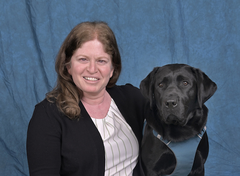 Graduate Bhavani and black Lab guide dog Anya