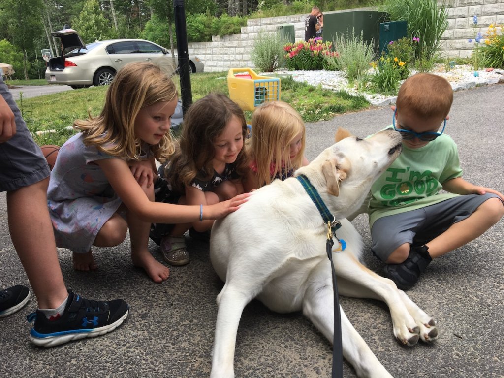 Pup Armstrong gives out puppy kisses to young friends