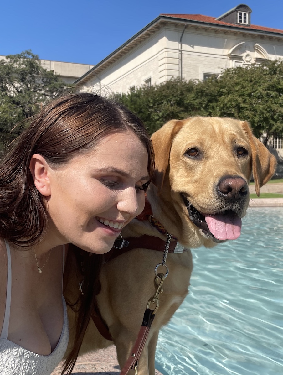 Brittany and Guide dog Todd pose by a shimmering pool