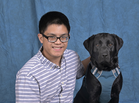 Graduate Casey and black Lab guide Kanga