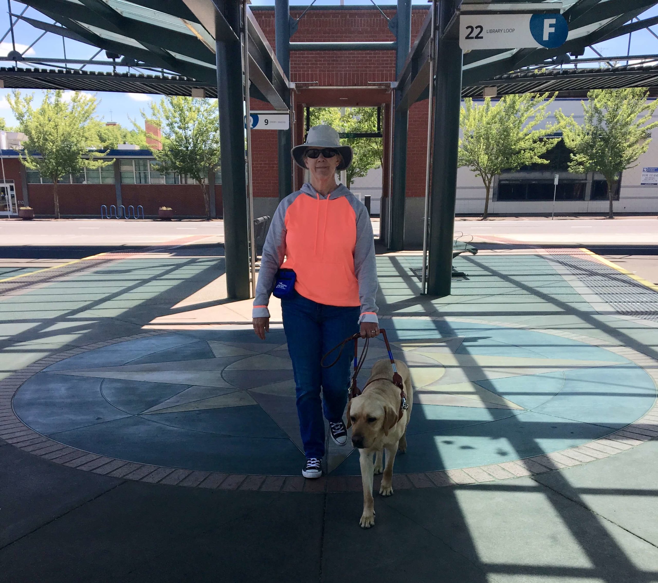 June graduate Donna and guide dog Eldon walking outside during a training session