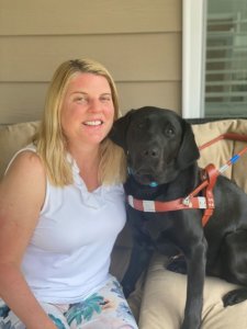 Grad Betsy and guide dog Emily take a break on the porch during training