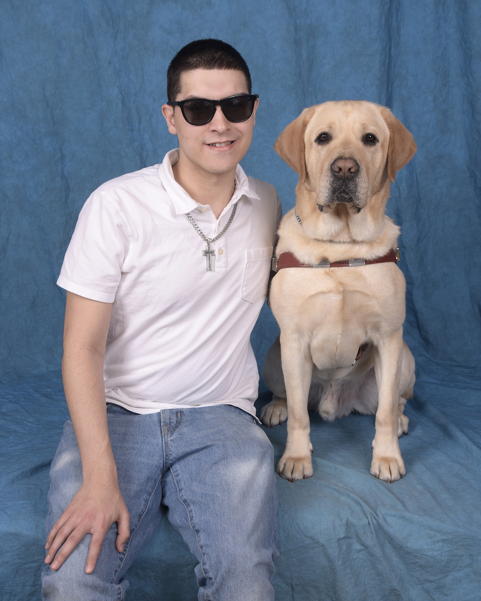 Graduate Ezrick and Yellow Lab guide dog Brutus