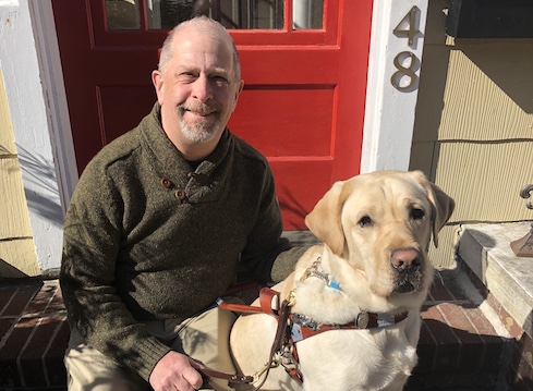 graduate Fred and yellow Lab guide dog Linus