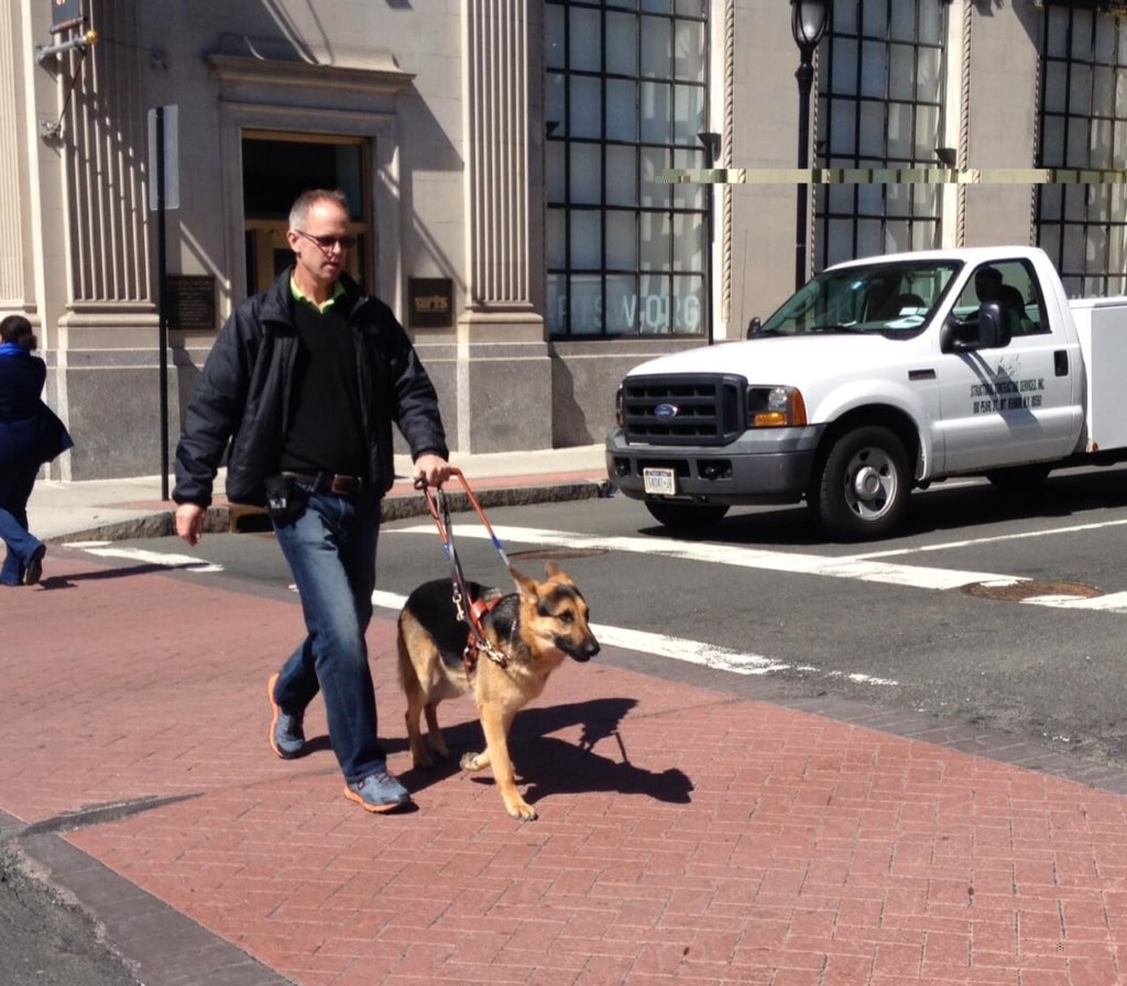Graham Buck works a street crossing with Guiding Eyes German shepherd guide dog Patton