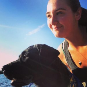 Alexandrea takes a selfie with black lab Twain on a beautiful day.