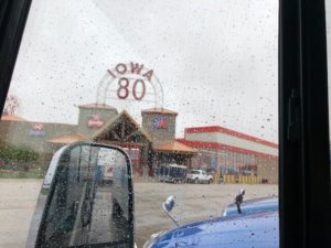 A photo of the 1-80 truck stop taken inside the motorcoach on a rainy day.