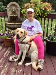 2018 graduate Jackie poses for a photo with guide dog Wilbur