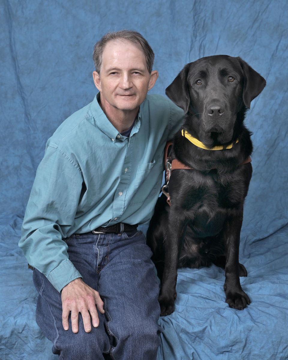 Graduate Jimmy and black Lab guide dog Judge