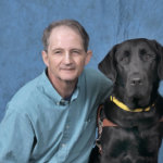 Graduate Jimmy and black Lab guide dog Judge