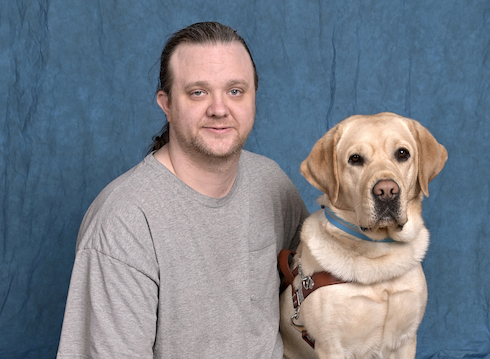 Graduate Joseph and yelllow Lab guide dog Pablo