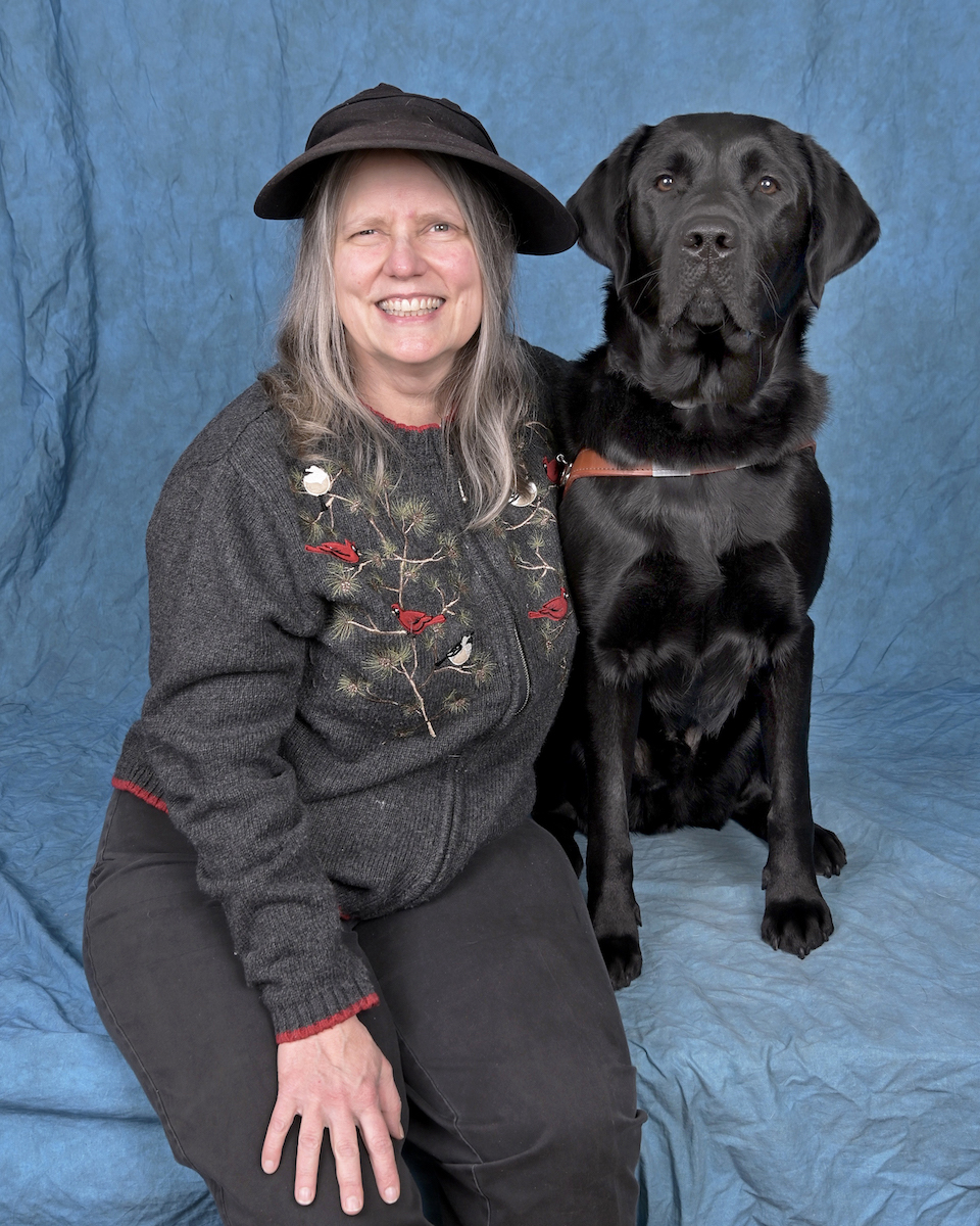 Graduate Judy and black Lab guide dog Orville