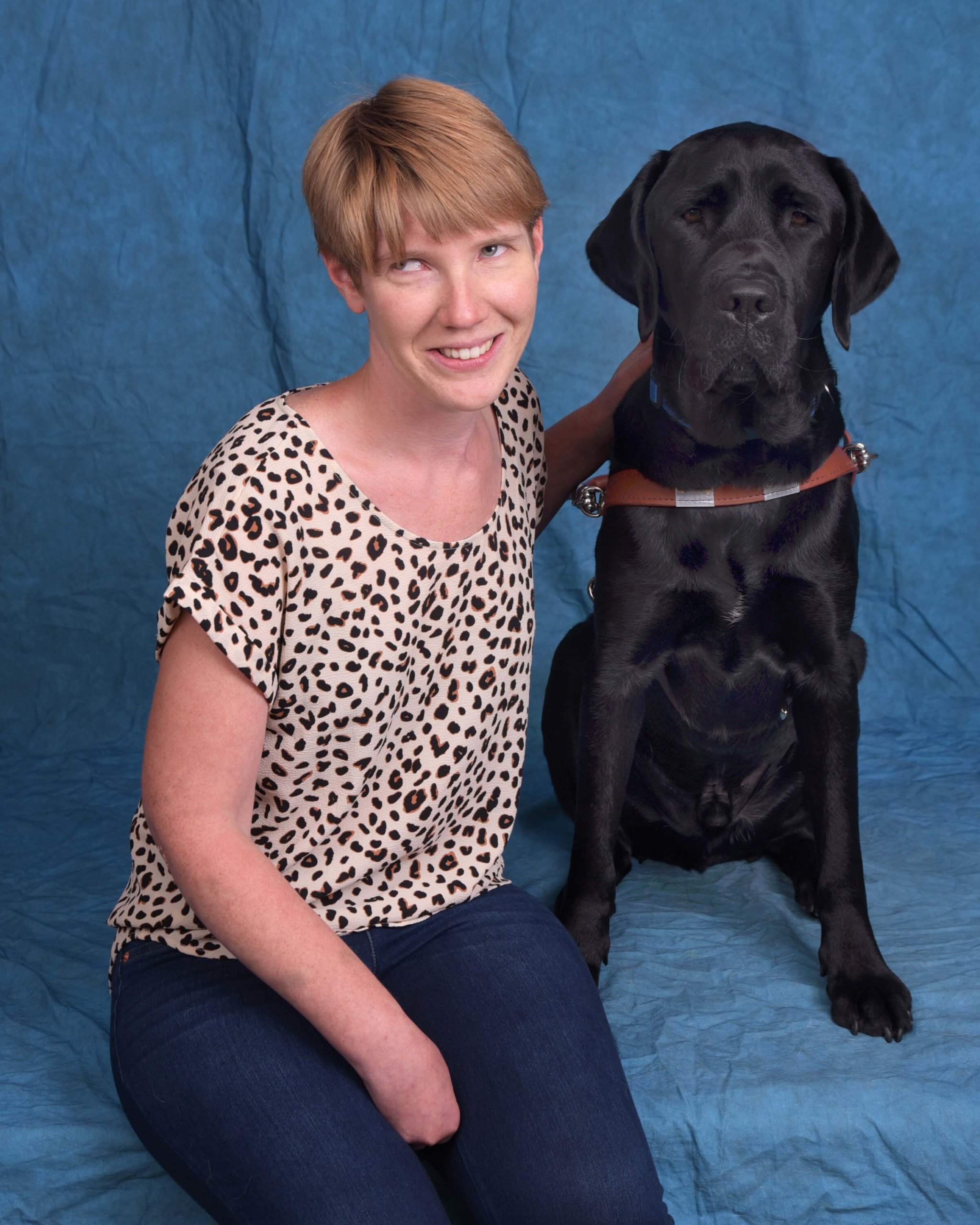 Kara and Jenkins, a black lab guide dog in harness.