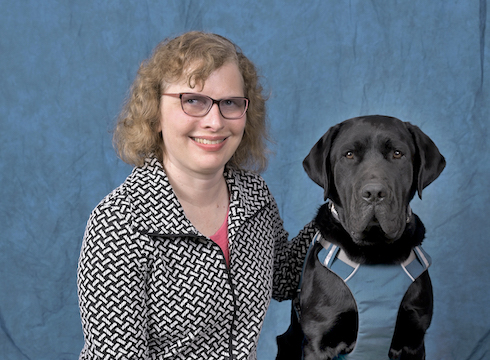 Graduate Kathy and black Lab guide dog Tate