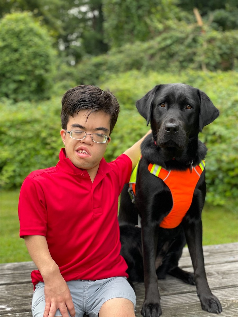 Graduate Keanu and guide dog black Lab Tilly