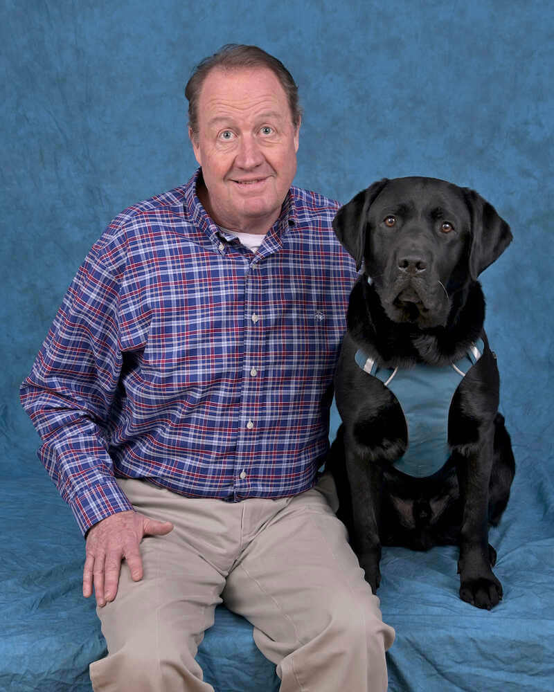 Graduate Kevin and black Lab guide dog Quanto