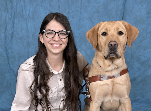 Graduate Mariana with yellow Lab guide dog Einstein