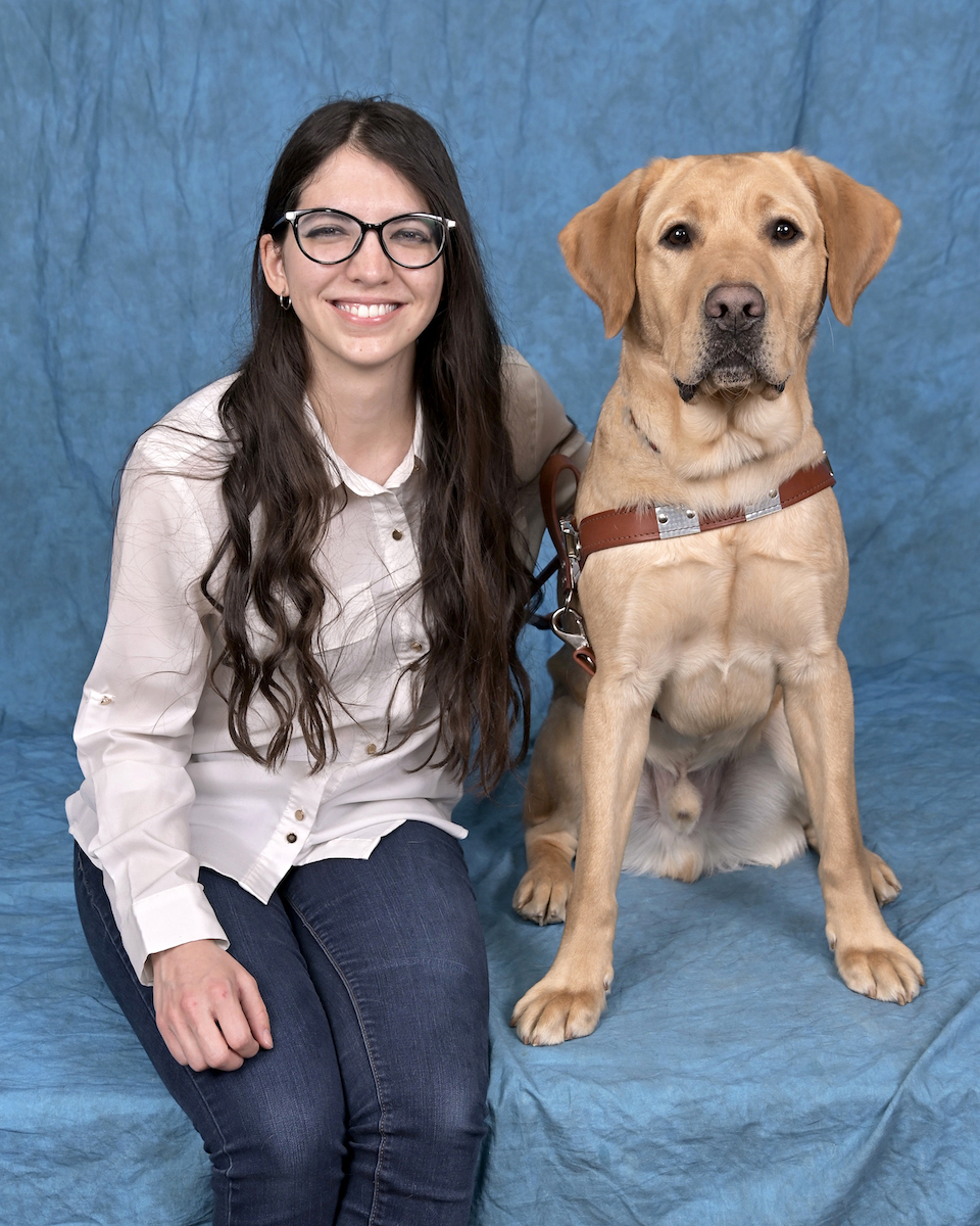 Graduate Mariana with yellow Lab guide dog Einstein