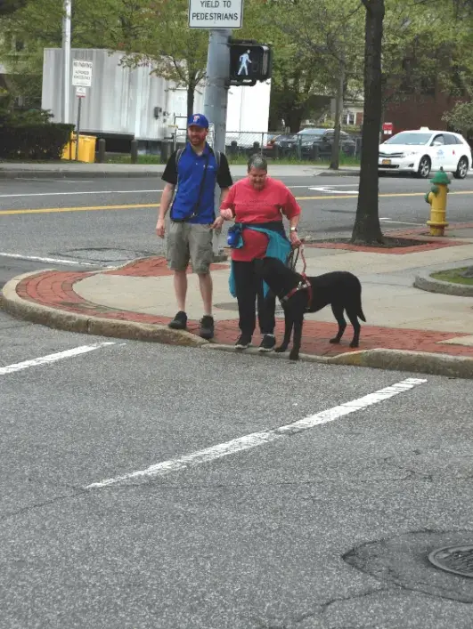 Nancy and Nate wait to cross an intersection during a training session