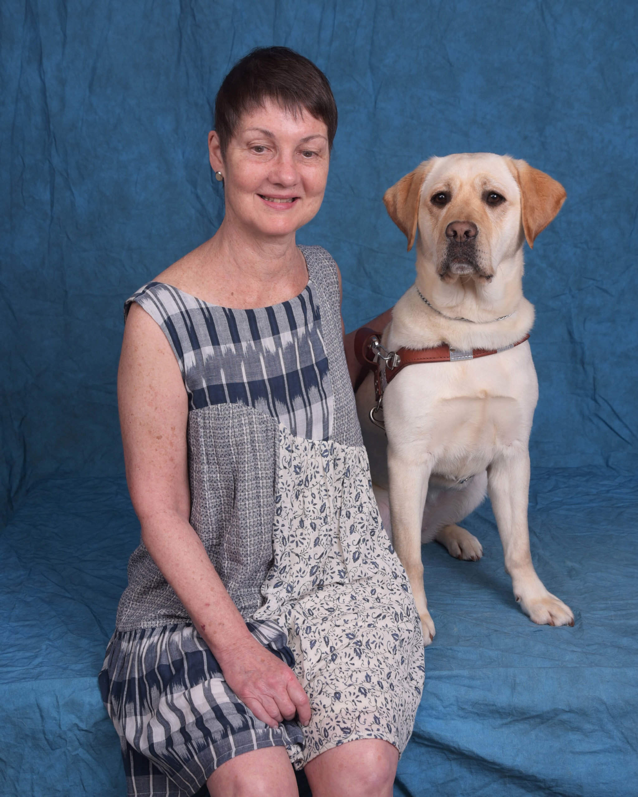 Rhonda and Tatum, a yellow lab guide dog in harness.