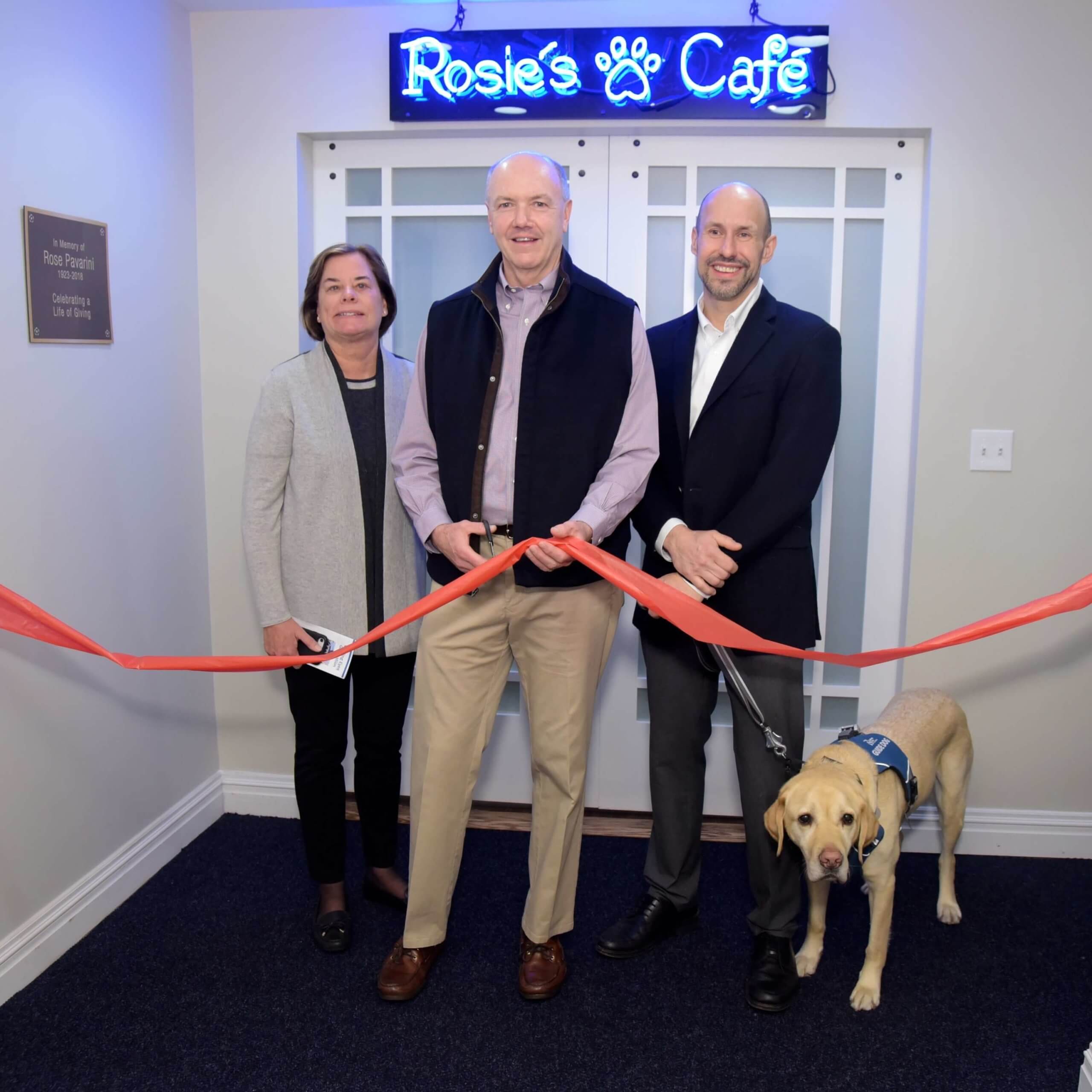 Board Chair John Donnelly cuts ribbon with wife Nancy, Tom and Gus