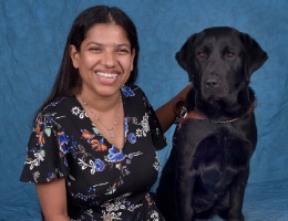 Graduate team Sajja and black lab guide dog Layla
