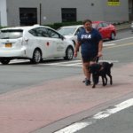 June graduate Ta'Lia & guide dog Kirby cross a street during a training session