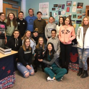 Volunteer and teacher Tara Kesel with her class of senior students along with black lab Starsky.
