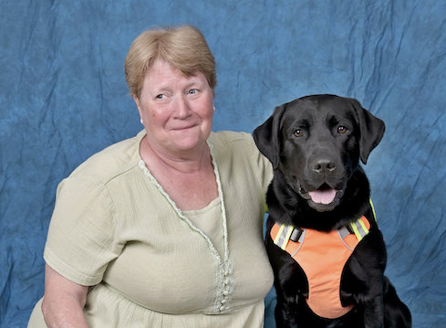 Graduate Theresa and black Lab guide dog Neville