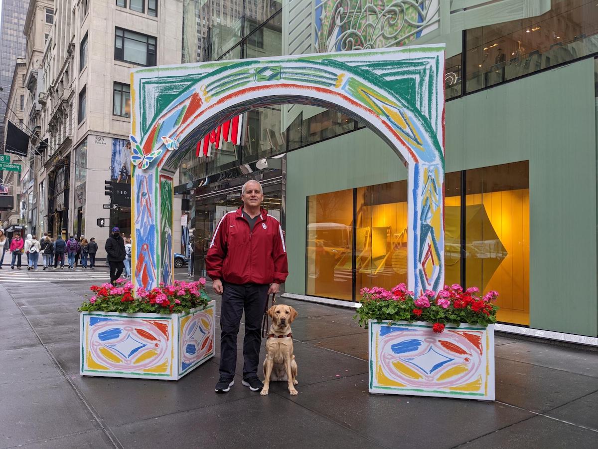 Tom and Holiday poses under an arch on the streets of NY