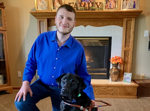 Graduate Tyler and black Lab guide dog Bodie