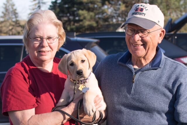 Puppy raisers Terry and Eileen Matro with Guiding Eyes pup Misty