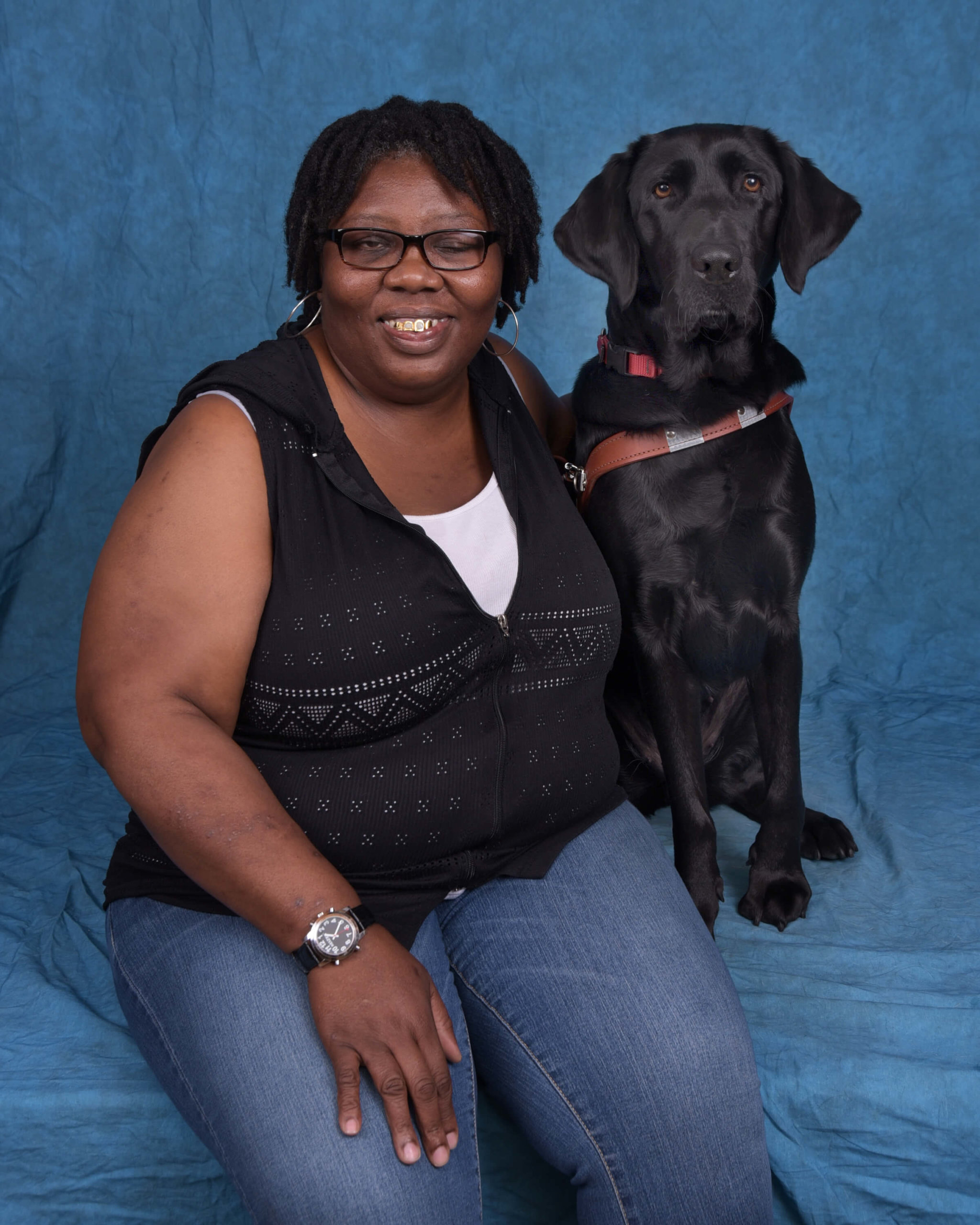 Formal photo of Verlisa with black lab guide dog Addie